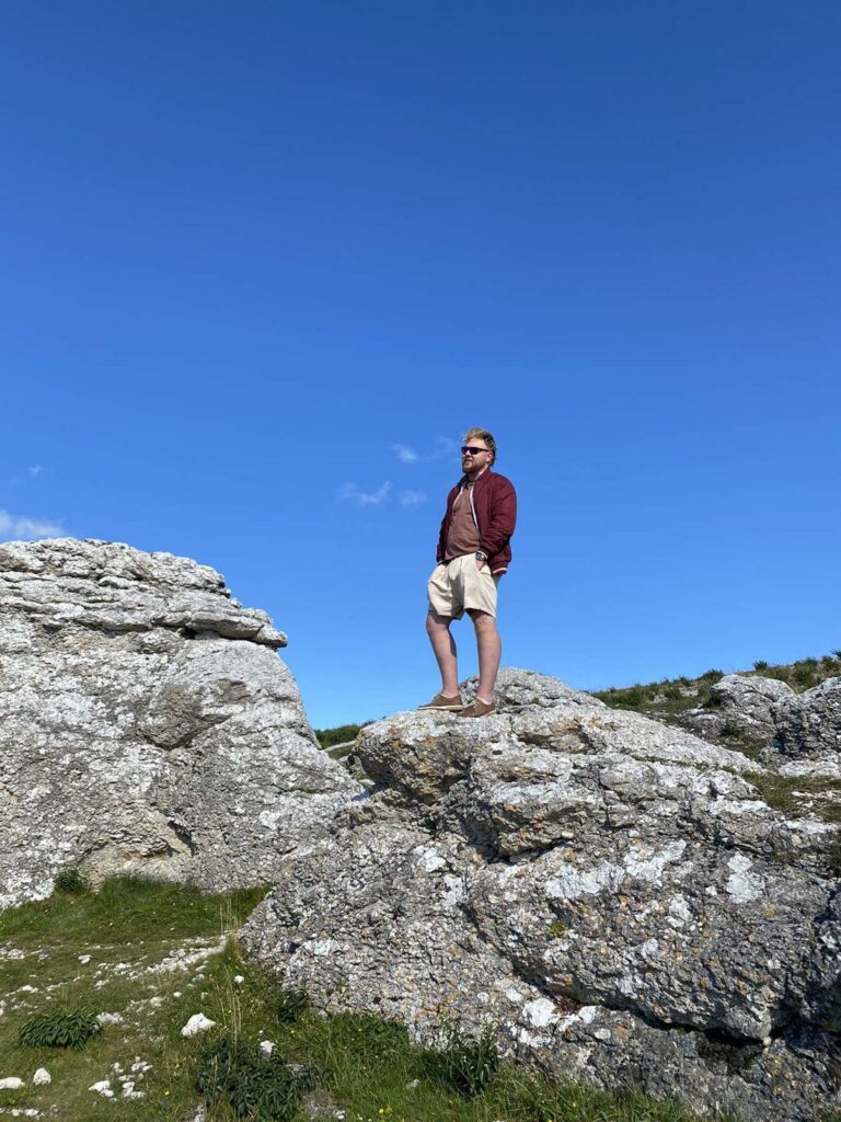 Linus founder of GSH standing on a rock